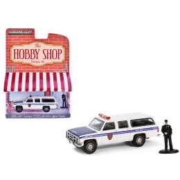 1985 GMC Suburban 2500 'New York City Transit Police Department' White with Blue Stripes and Police Officer Figure 'The Hobby Shop' Series 16 1/64 Diecast Model Car by Greenlight